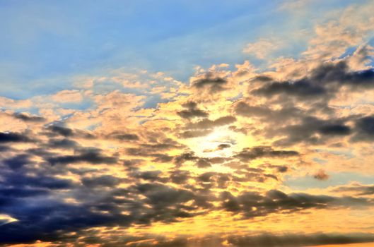 Beautiful panorama of orange and yellow clouds at sunrise and sunset in a blue sky