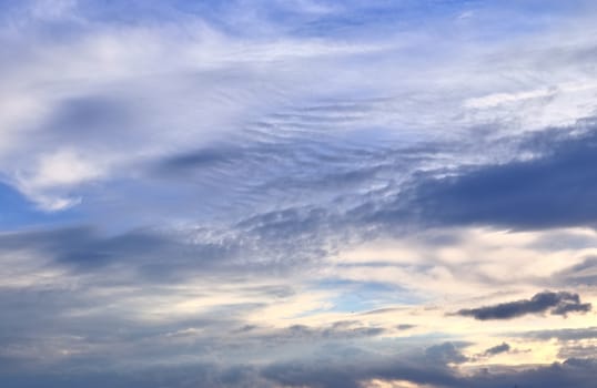 Beautiful panorama of orange and yellow clouds at sunrise and sunset in a blue sky