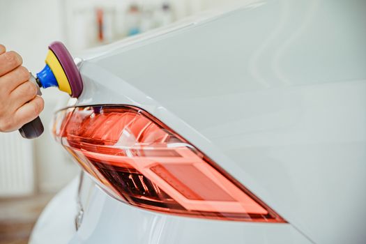 manual polishing of the body of luxury cars with the application of ceramic protective equipment.