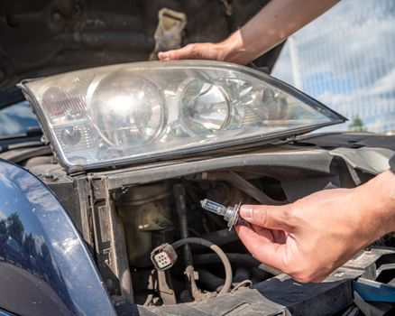 car headlight repair by replacing bad bulbs with new ones.