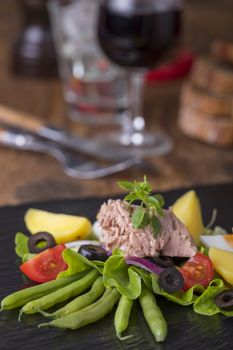 salad nicoise on a wooden background