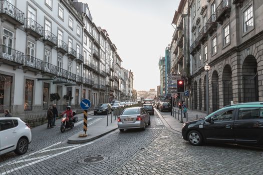 Porto, Portugal - November 30, 2018: Architecture detail and street atmosphere in the historic city center where people walk on a winter day