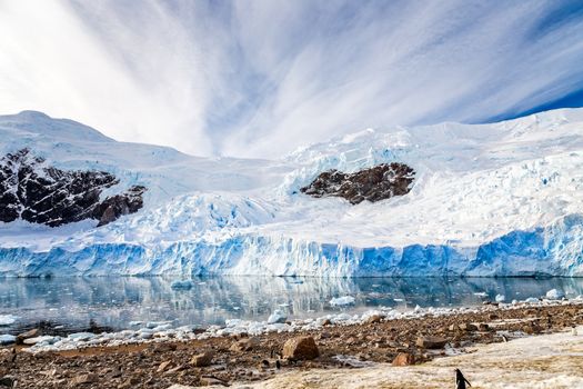 Huge Antarctic glacier reflected in the Antarctic waters of Neco bay, Antarctica