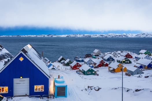 Colorful inuit huts among rocks and snow at the fjord in a suburb of arctic capital Nuuk, Greenland88