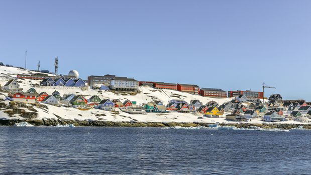 Lots of Inuit huts and colorful houses situated on the rocky coast along the fjord, Nuuk city, Greenland8