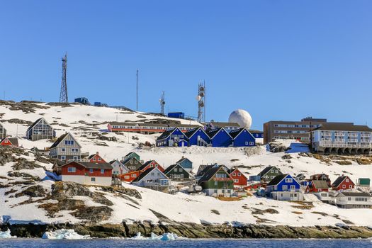 Lots of Inuit huts and colorful houses situated on the rocky coast along the fjord, Nuuk city, Greenland8