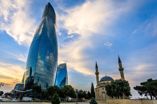 Mosque of the Martyrs and modern glass central business district skyscrapers in the sunset, Baku, Azerbaijan