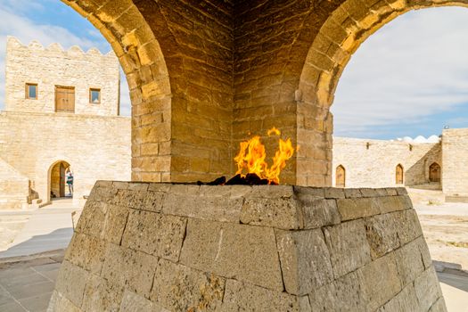 Ancient stone temple of Atashgah with burning flame inside, Zoroastrian place of fire worship, Baku, Azerbaijan