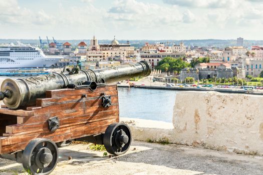 El Morro spanish fortress with cannon aimed to Havana city and liner docked in the port, Havana, Cuba