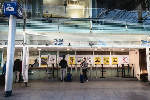 Dublin, Ireland - February 15, 2019: Passengers buying a ticket in the Connolly DART train station (Staisiun ui Chonghaile) on a winter day