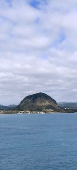 Beautiful view of mountain Sanbang-san across the ocean in jeju island