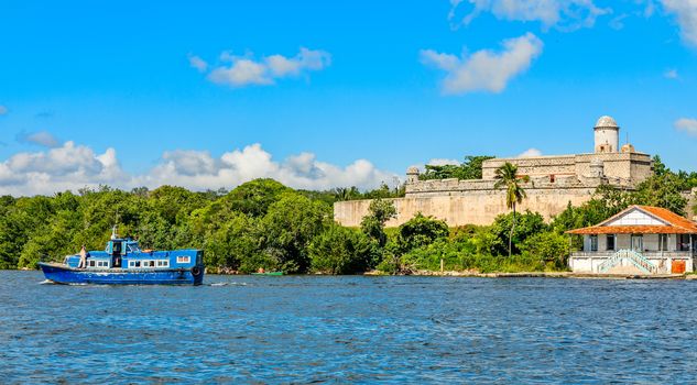Jagua castle fortified walls with trees and fishing boats in the foreground, Cienfuegos province, Cuba