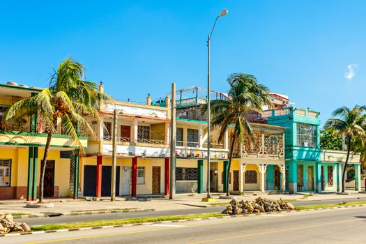 Old Spanish colonial houses with palms along the street in the center of Cienfuegos, Cuba