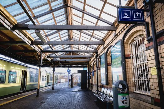 Howth near Dublin, Ireland - February 15, 2019: Passengers walking on the platform of the Howth Binn Eadair DART train station on a winter day