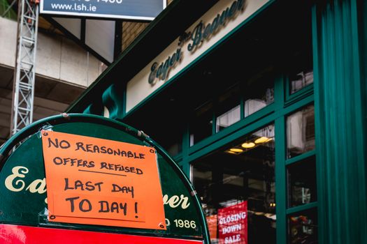 Dublin, Ireland - February 16, 2019: No reasonable offers refused - Last day to day - on a street sign outside a city center store on a winter day