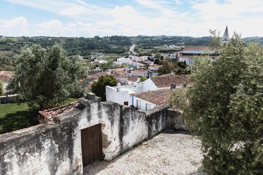 Obidos, Portugal - April 12, 2019: View of the countryside and the houses surrounding the city on a spring day