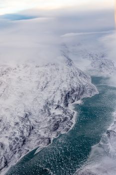 Greenlandic ice cap with frozen mountains and river aerial view, near Nuuk, Greenland
