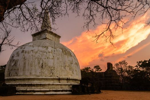 Kiri Vehere old buddhist stupa temple at sunset time with burning cloud in the background, Polonnaruwa, Sri Lanka