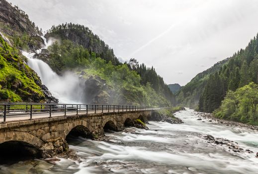 Latefoss waterfalls streams under the stone bridge archs, Odda, Hordaland county, Norway