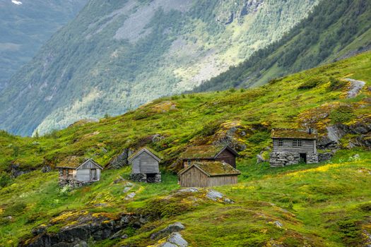 Norwegian mountain village with traditional turf roof houses, Geiranger, Sunnmore region, More og Romsdal county, Norway