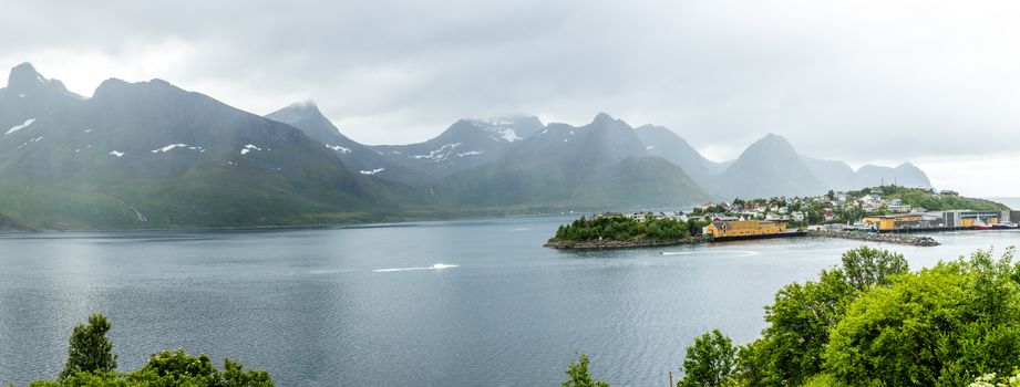 Husoy island village panorama with mountains in the background, Senja island, Troms county, Norway