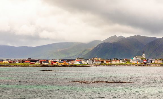 Andenes village panorama with multiple houses and mountains in the background, Lofoten islands, Andoy Municipality, Vesteralen district, Nordland county, Norway
