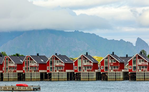 Red norwegian fishing houses rorbu at pier in Svolvaer, Lototen islands, Austvagoya, Vagan Municipality, Nordland County, Norway