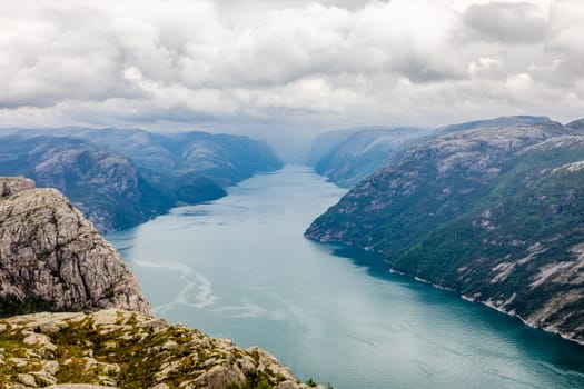 Panoramic mountain view to the long narrow and blue Lysefjord, Prekestolen hiking trail, Forsand, Rogaland county, Norway.