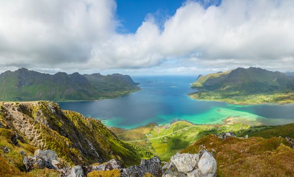 View from the top of Kleppstadheia mountain to the bay with turquoise water, and Rystad and Toe  villages on the shores Austvagoya, Lofoten islands, Norway