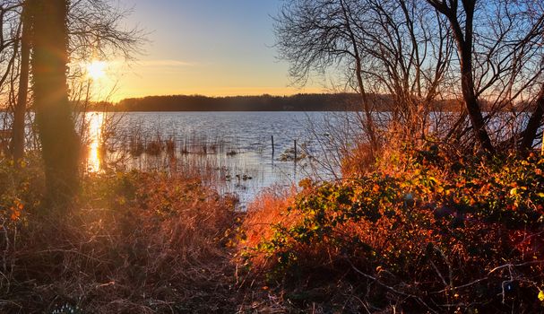 Beautiful and romantic sunset at a lake in stunning yellow and orange colors