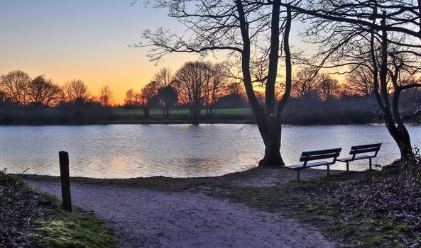 Beautiful and romantic sunset at a lake in stunning yellow and orange colors