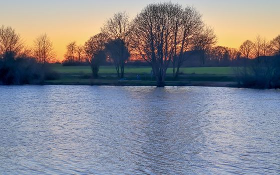 Beautiful and romantic sunset at a lake in stunning yellow and orange colors