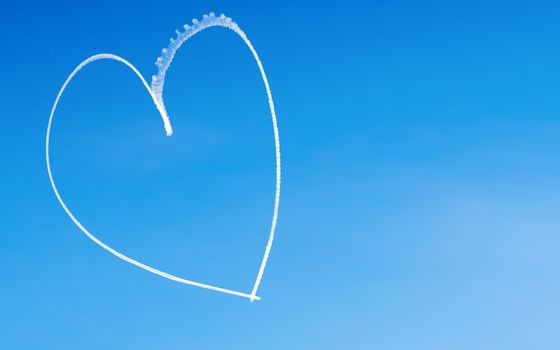 Romantic heart written by an aircraft in the sky, with copy space. Concept for Valentine's day