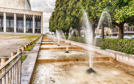 Scenic fountain, iconic neoclassical architecture in the EUR district, Rome, Italy