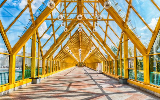 Walking inside Pushkinsky Pedestrian Covered Bridge near Gorky Park in central Moscow, Russia