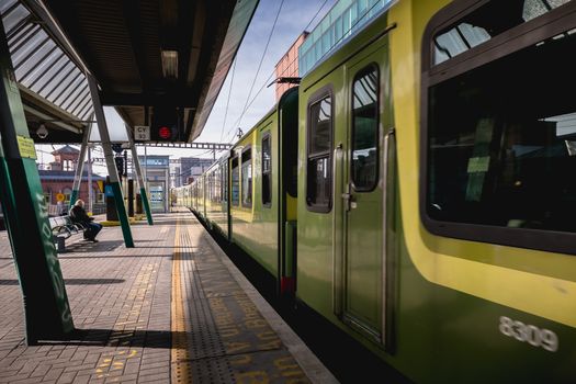 Dublin, Ireland - February 15, 2019: Passengers walking on the platform of Connolly DART train station (Staisiun ui Chonghaile) on a winter day