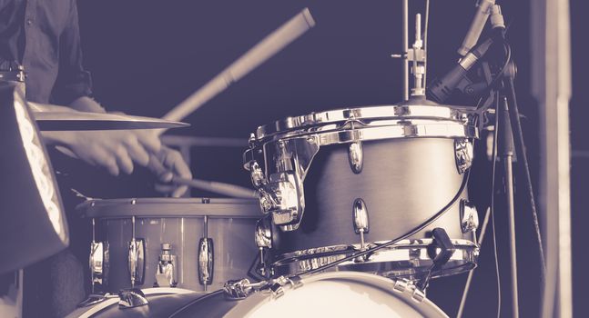 Close up of hands of a man playing a drums. black and white image