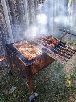 Steel barbecue trolley. convenient barbecue. frying meat on the grill.