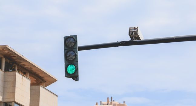 Valencia, Spain - June 16, 2017: detail of a tricolor traffic light radar in the city center on a summer day