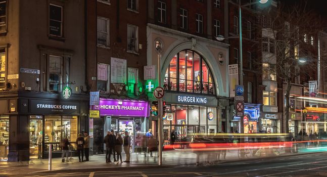 Dublin, Ireland - February 15, 2019: street atmosphere and architectural detail at night in the historic city center where people walk on a winter evening