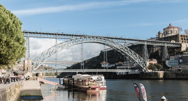 Porto, Portugal - November 30, 2018: View of the Luizi Bridge and the atmosphere around with people walking on an autumn day