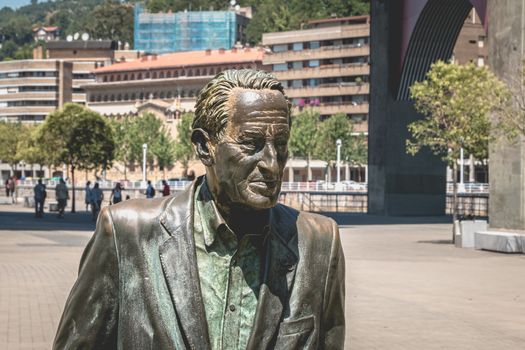 Bilbao, Spain - July 19, 2017: Monument of the socialist leader Ramon Rubial Cavia by Casto Solano, In front of the Guggenheim museum on a summer day