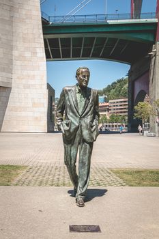 Bilbao, Spain - July 19, 2017: Monument of the socialist leader Ramon Rubial Cavia by Casto Solano, In front of the Guggenheim museum on a summer day