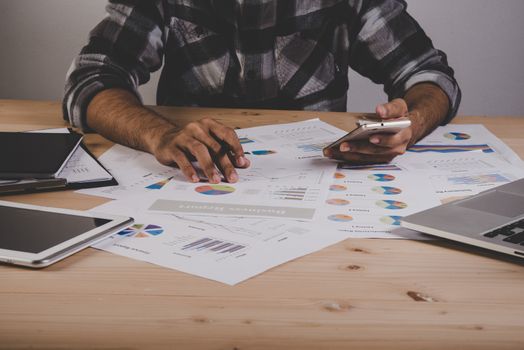 Young businessman analyzing data in office.