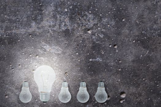 Light Bulbs Concept gray cement background