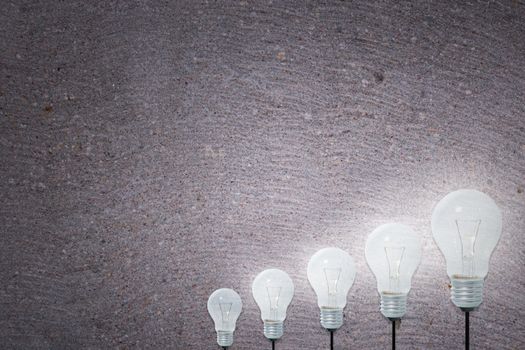 Light Bulbs Concept gray cement background
