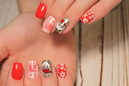 Beautiful woman's nails with beautiful christmas manicure studio