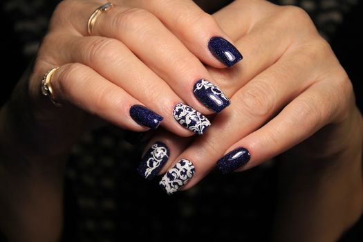 Beautiful woman's nails with beautiful christmas manicure studio