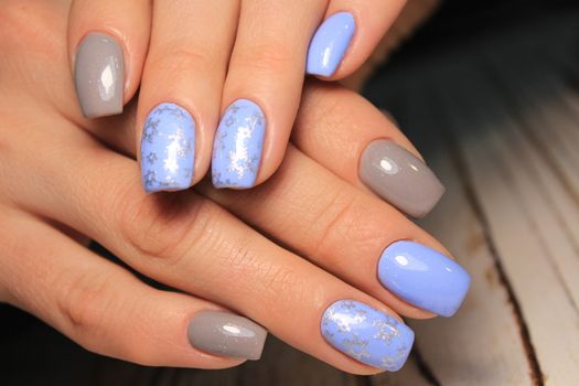 Closeup photo of a beautiful female hands with elegant manicure and diamond rings.