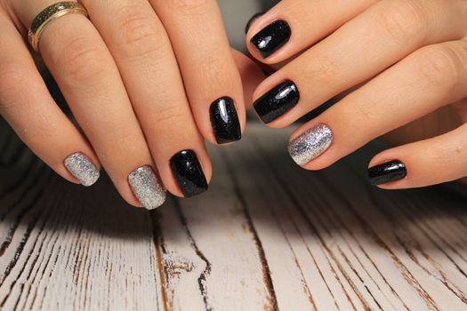 Closeup photo of a beautiful female hands with elegant manicure and diamond rings.